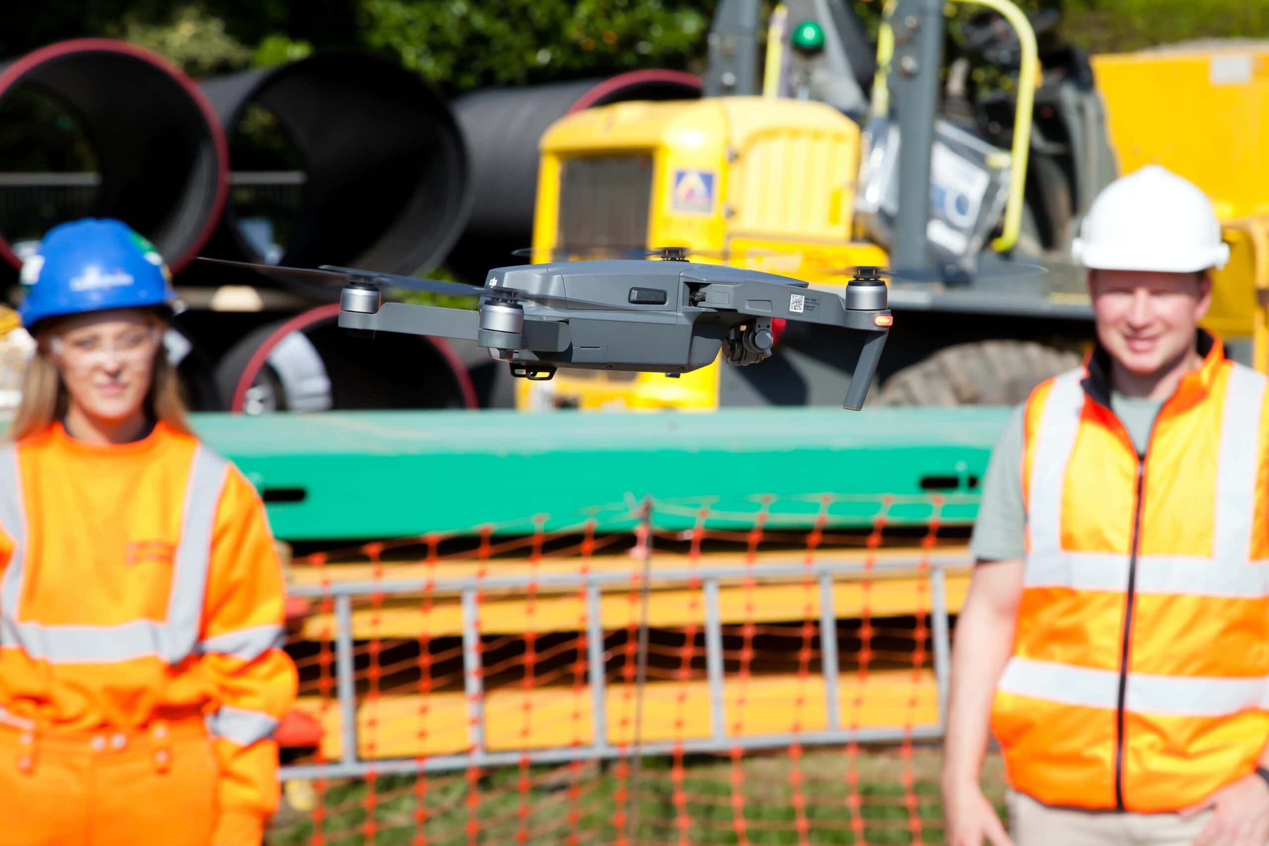 Construction workers watching a drone in flight